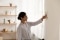 woman adjusting a thermostat