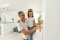 an adult and child look at a thermostat